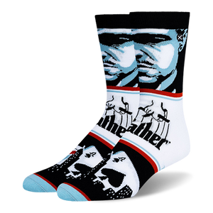 Crew socks with a blue and black Godfather portrait, the classic puppeteer logo, and playing cards over a city skyline.