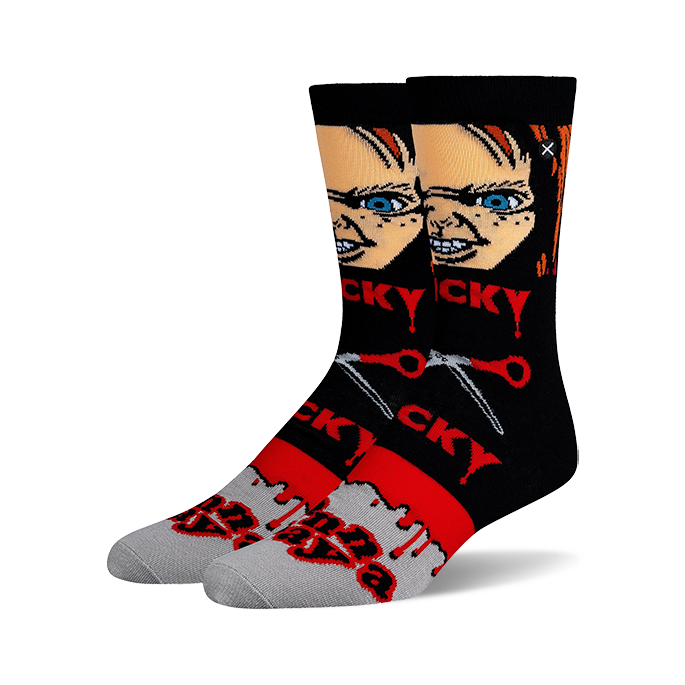 A pair of black crew socks with a Chucky image, red dripping paint, and the words "Wanna Play" in red. 