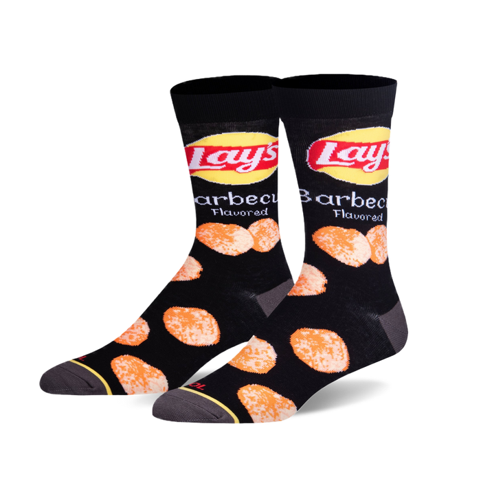 Pair of black crew socks with a fun design featuring the Lay's BBQ chips logo and scattered chip imagery.