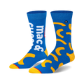 A pair of blue crew socks with a Kraft Mac & Cheese design. Yellow macaroni shapes and 'Mac & Cheese' text are featured.