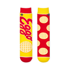 Flat lay of mismatched socks. The left yellow sock has a large red Eggo logo. The right red sock has a waffle pattern.