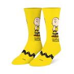 Bright yellow crew socks featuring a pensive Charlie Brown illustration on the leg and his signature black zigzag stripe.