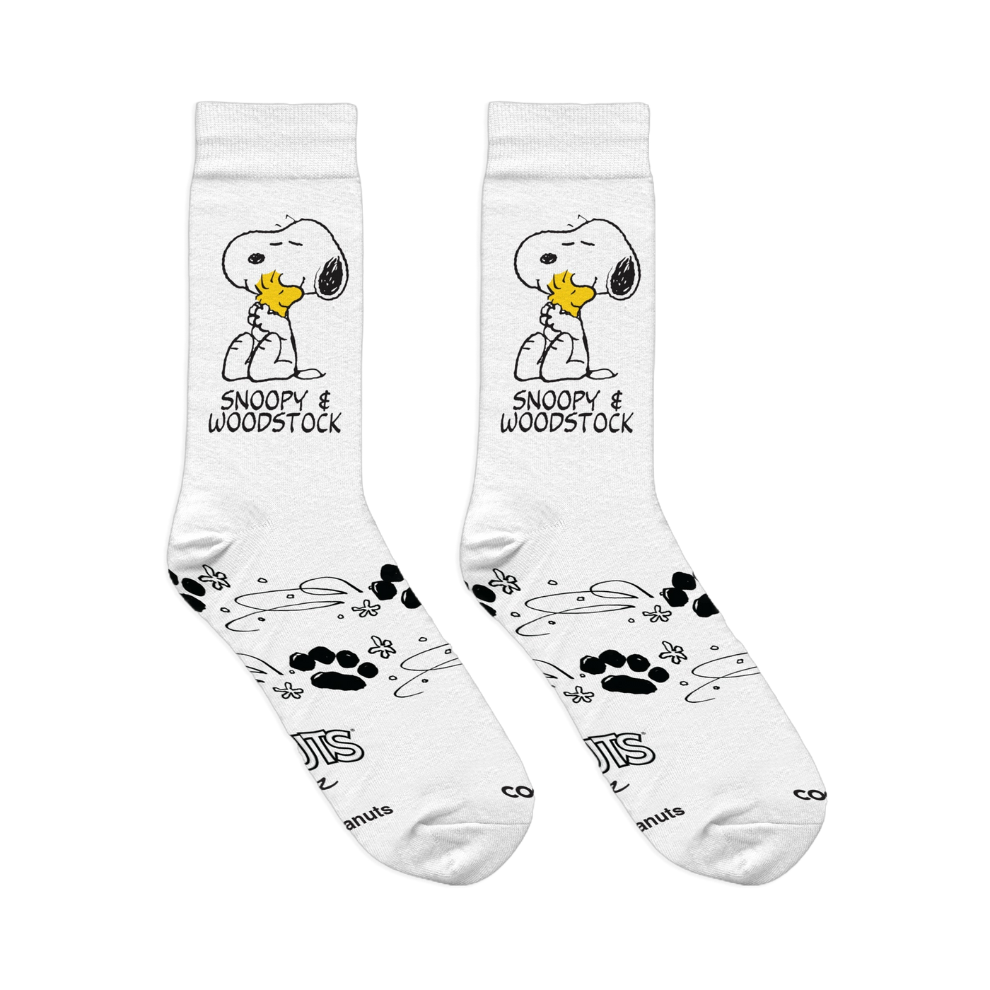 Flat lay of white crew socks showing Snoopy hugging Woodstock, paired with paw prints, swirls, and Peanuts copyright text.