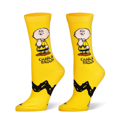 Yellow crew socks showing Charlie Brown thinking, his name in text, and his classic thick black zigzag stripe pattern.
