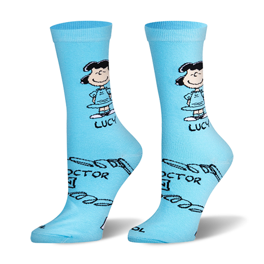 Light blue crew socks featuring the cartoon character Lucy standing with hands on hips and parts of her Doctor is In sign.