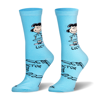 Light blue crew socks featuring the cartoon character Lucy standing with hands on hips and parts of her Doctor is In sign.