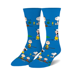 Crew socks in bright blue featuring Peanuts characters like Snoopy and Charlie Brown engaged in outdoor activities. 