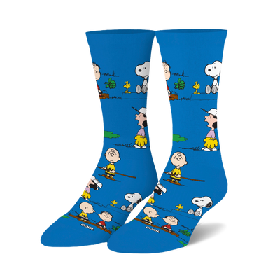 Pair of bright blue crew socks with a repeating pattern of Charlie Brown, Snoopy, Woodstock, and Linus in outdoor settings.