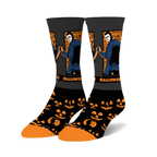 Pair of Halloween II crew socks. Black background with orange jack-o'-lanterns, Michael Myers image and Halloween II text.