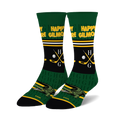 Pair of Happy Gilmore crew socks. Green, black, and white design with alligator, hockey sticks, golf clubs, and Happy Gilmore text.