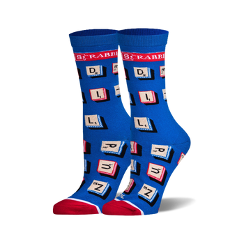 A pair of women's crew socks in blue with red and white accents. The socks are covered in Scrabble letter tiles.