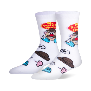 White crew socks featuring the Mr. Potato Head logo and character on the calf, with scattered loose toy parts on the foot.