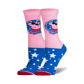 A pair of pink and blue crew socks.  Peppa Pig, wearing sunglasses, is featured on the pink portion. The blue portion is covered in white stars.
