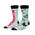 A pair of mint green crew socks. Left sock has a red Monopoly logo. Right sock has Monopoly game piece symbols. Black cuffs/toes.