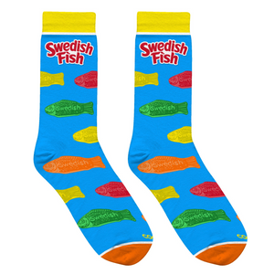 Lifestyle shot: Two pairs of Swedish Fish socks casually draped over a light-colored surface. Shows the socks' design and color well.
