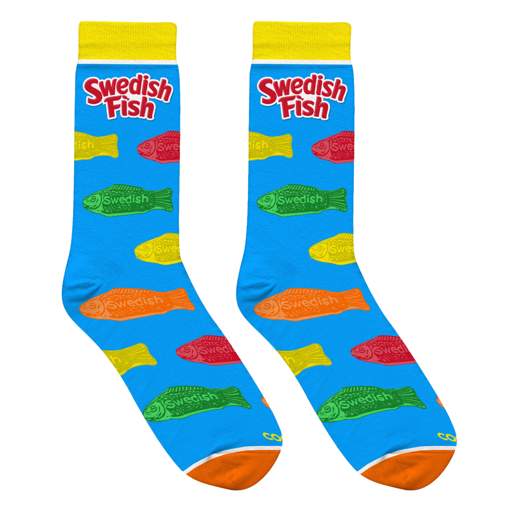 Lifestyle shot: Two pairs of Swedish Fish socks casually draped over a light-colored surface. Shows the socks' design and color well.