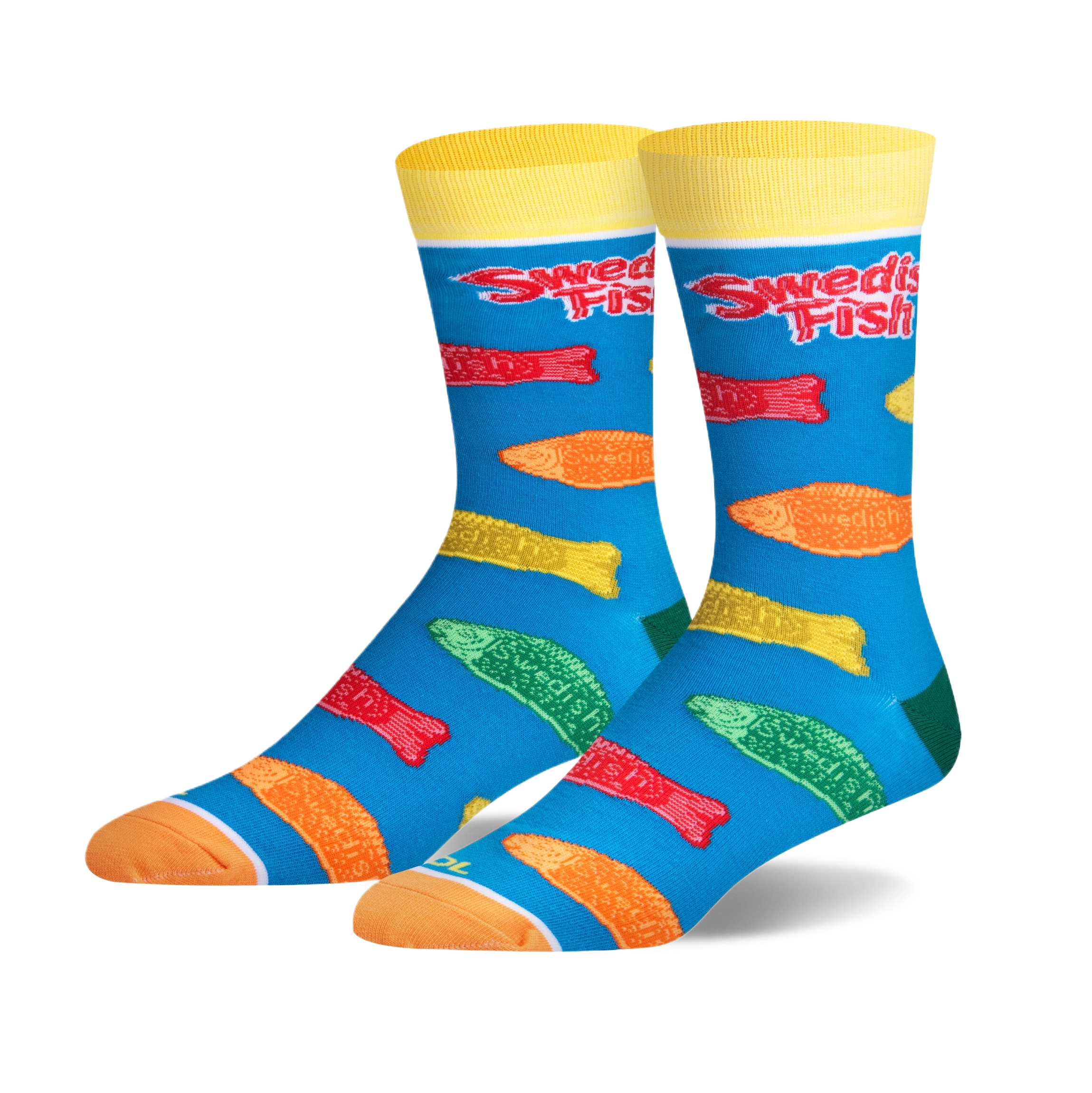 Pair of crew socks with a teal background. Features colorful Swedish Fish candy printed on them, and yellow cuffs with 'Swedish Fish' logo.