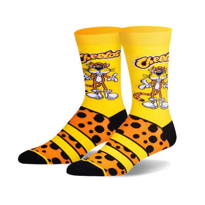 Pair of crew socks with Chester Cheetah on yellow background, orange cheetah print, black toes and heels.