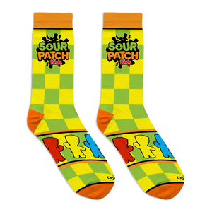 Flat lay of Sour Patch Kids socks showing yellow and green checkers, the logo, and a panel of colorful candy figures.