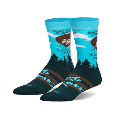 Crew socks in teal, dark green, and brown.  Feature Bob Ross's portrait, his quote, and a pine forest scene.