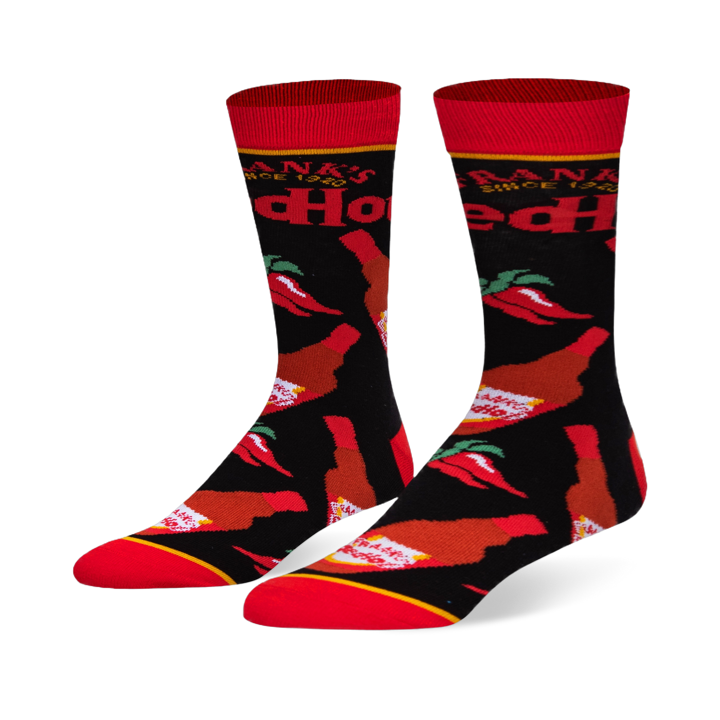 Black crew socks featuring a pattern of Frank's RedHot sauce bottles and red chili peppers, with a bright red toe and cuff.