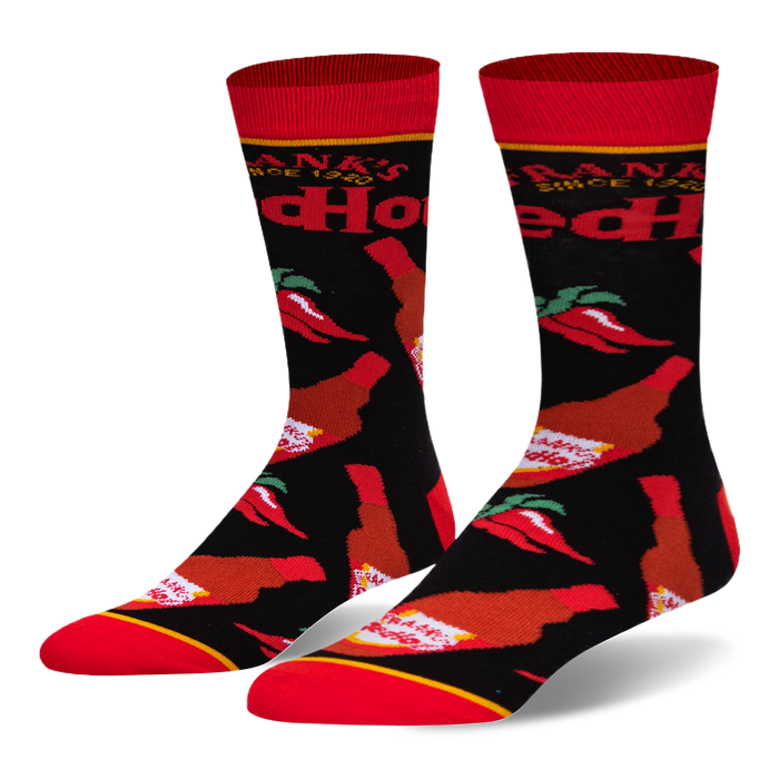 Black crew socks featuring a pattern of Frank's RedHot sauce bottles and red chili peppers, with a bright red toe and cuff. }}