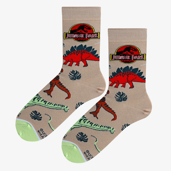 A pair of Jurassic Park dino socks laid flat, showcasing the design details and color scheme.