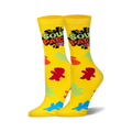 A pair of yellow crew socks. The socks are decorated with the Sour Patch Kids logo and colorful candy-shaped designs.