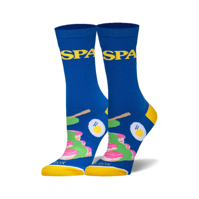 Pair of blue crew socks with yellow heels, toes, and cuffs. Design shows Spam slices, fried eggs, and yellow stick shapes.