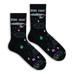 Flat lay of two black Star Trek socks showing the Enterprise ship and colorful orbiting planets.