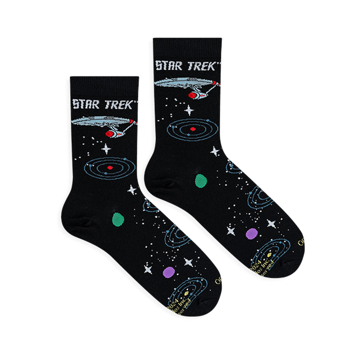 Flat lay of two black Star Trek socks showing the Enterprise ship and colorful orbiting planets.
