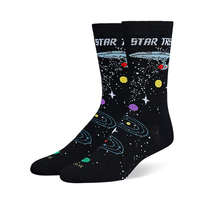 Black Star Trek crew socks showing the USS Enterprise, retro logo text, white stars, and colorful orbiting planets.