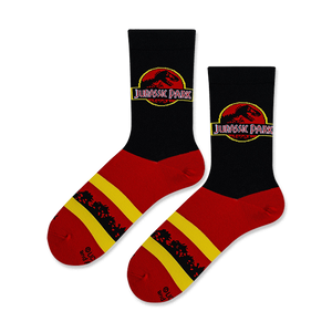 Lifestyle shot of Jurassic Park logo socks on a model's feet.