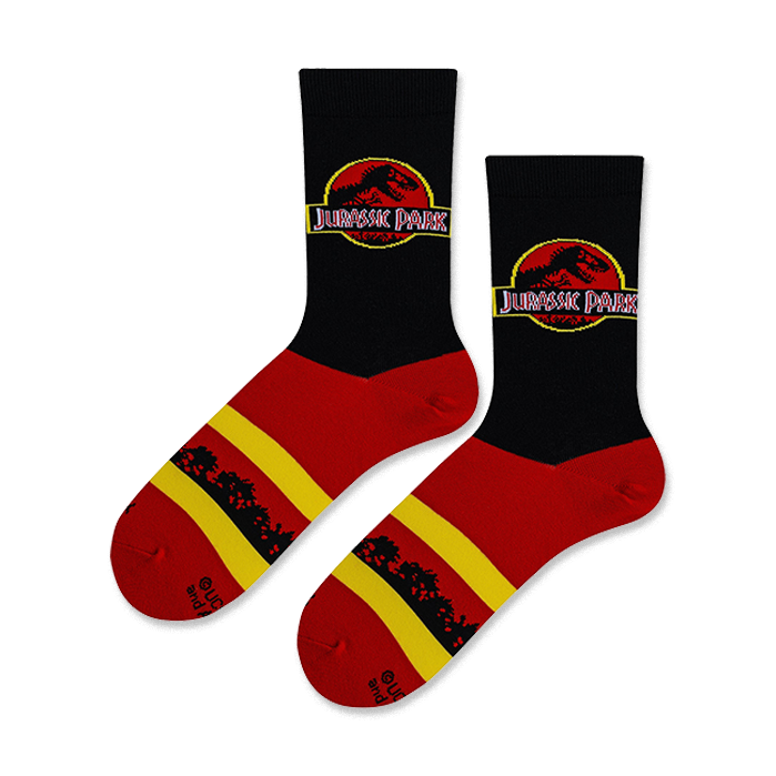 Lifestyle shot of Jurassic Park logo socks on a model's feet.