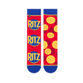 Flat lay of red mismatched socks. Left sock shows three stacked Ritz logos. Right sock displays a scattered cracker pattern.