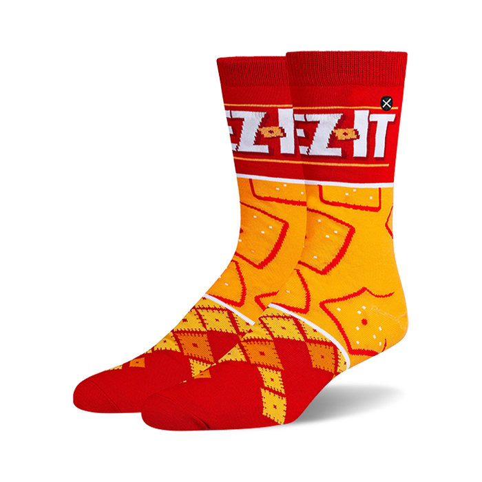 Pair of crew socks in red and orange.  Features a Cheez-It box design at the top and a pattern of Cheez-It crackers.
