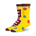 Crew socks in yellow with brown cuffs, featuring the M&Ms logo and multicolored M&Ms candies scattered across the design.