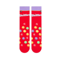 Flat lay of two red Skittles socks showing the light purple cuff, white logo, and scattered multi-colored candy pattern.