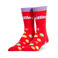Bright red crew socks featuring a purple cuff, the white Skittles logo, and scattered colorful candy pieces with white S marks.