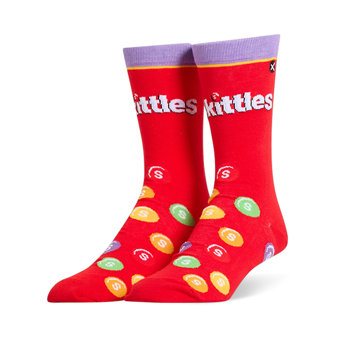 Bright red crew socks featuring a purple cuff, the white Skittles logo, and scattered colorful candy pieces with white S marks.
