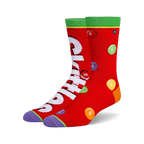 Pair of crew socks, predominantly red, featuring a Skittles design with the Skittles logo and multicolored candies printed on them.