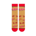 Flat lay of two tan crew socks side by side showing red cuffs, large Twix logos, and a pattern of snapped candy bars.