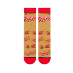 Flat lay of two tan crew socks side by side showing red cuffs, large Twix logos, and a pattern of snapped candy bars.