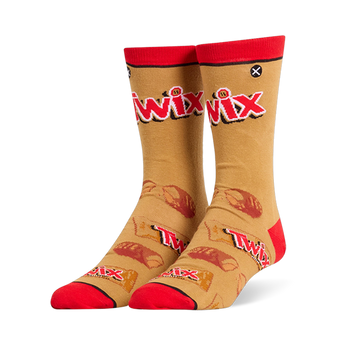 Tan crew socks featuring a large red Twix logo, red cuffs and toes, and a pattern of wrapped and broken candy bars.