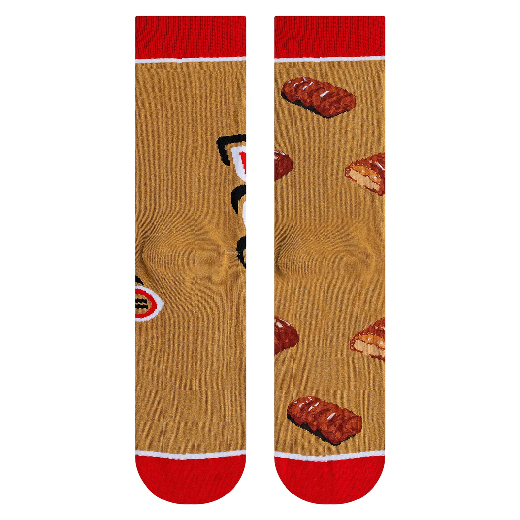 Close-up shot highlighting the fabric texture and detailed Twix bar illustrations on the socks.