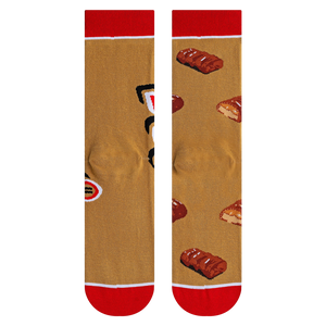 Close-up shot highlighting the fabric texture and detailed Twix bar illustrations on the socks.