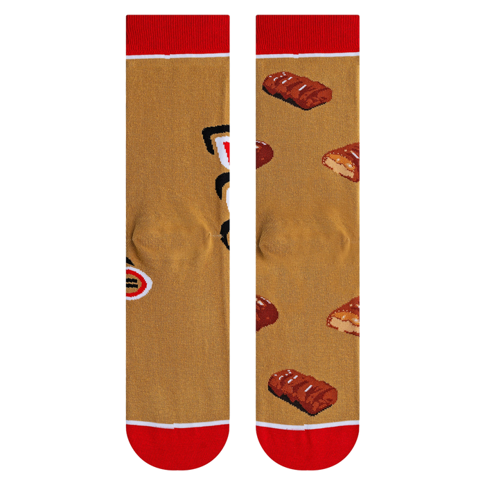 Close-up shot highlighting the fabric texture and detailed Twix bar illustrations on the socks.
