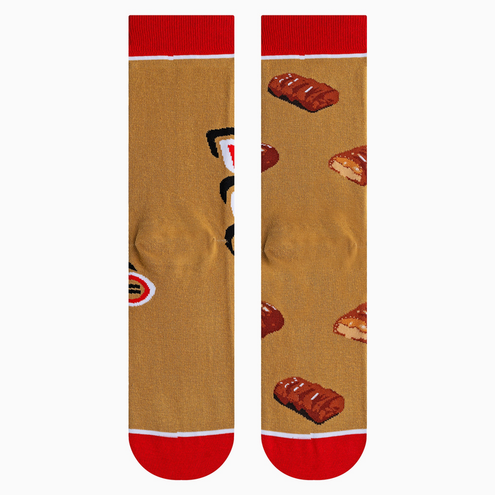 Close-up shot highlighting the fabric texture and detailed Twix bar illustrations on the socks.