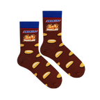 Flat lay of two brown socks showing the Snickers logo, a candy bar cross-section, and scattered peanut halves.