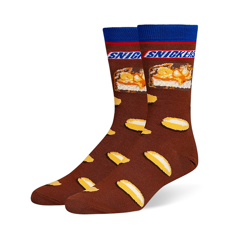 Brown crew socks featuring a blue cuff, the Snickers logo, a candy bar cross-section, and a scattered peanut pattern.
